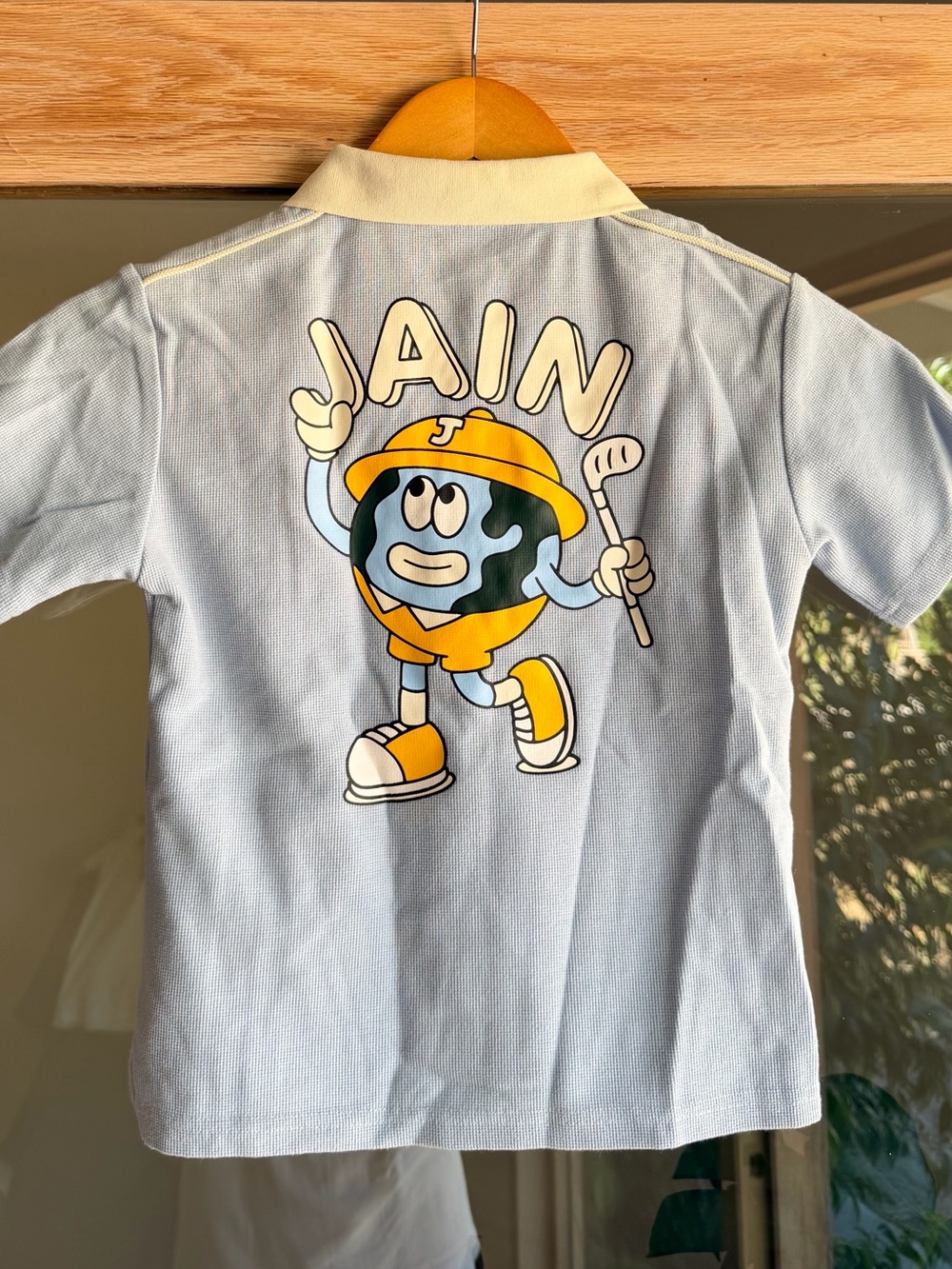 Light Blue Kids Polo with Playful Mascot Graphic